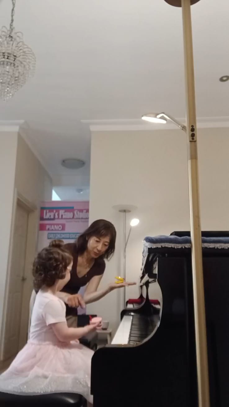 Ms Lien teaching a young student